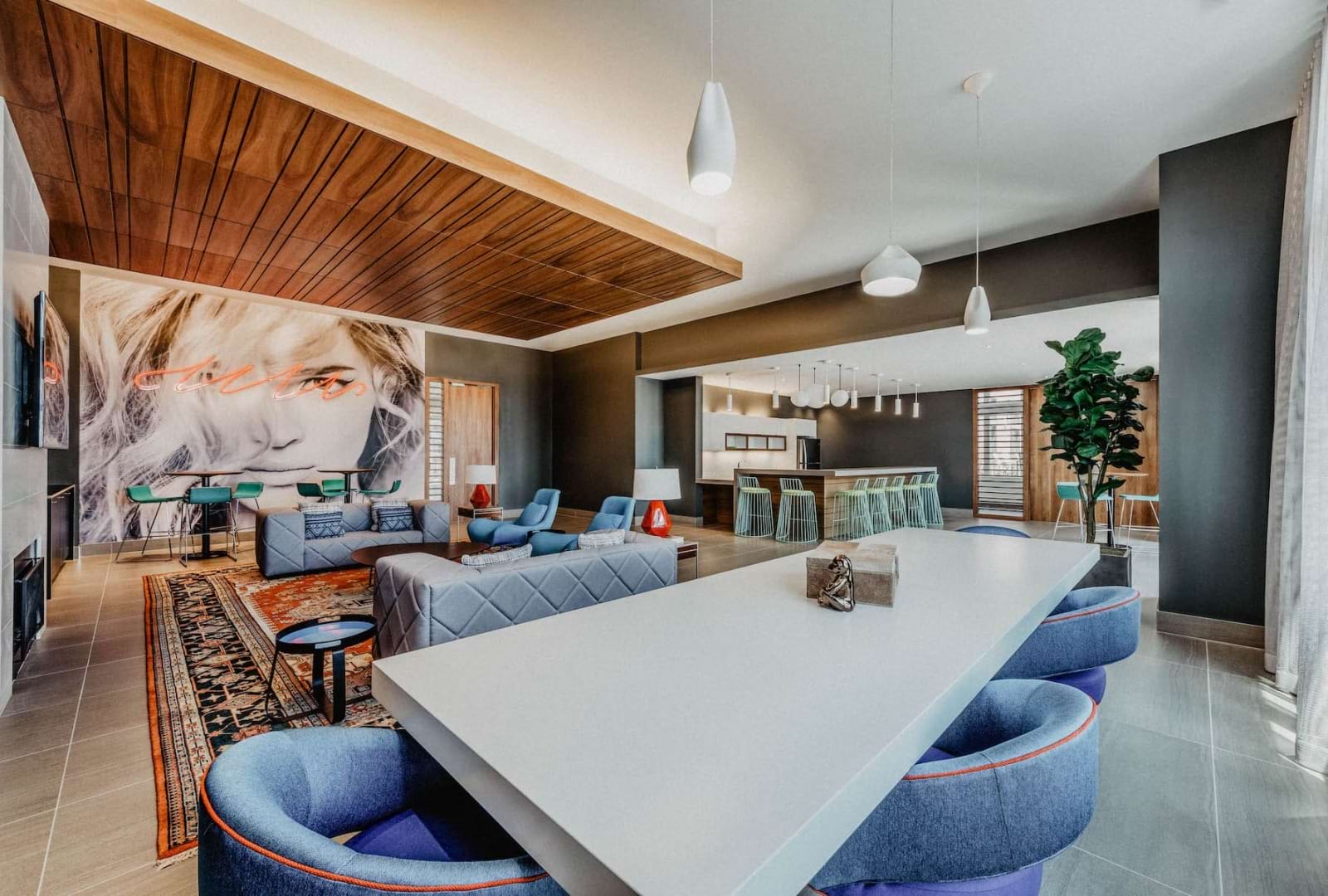 lounge room with a large community table, modern art-decor and easy access to additional seating areas